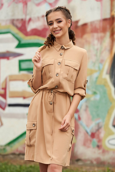 Cream dress casual short cut flared with pockets is fastened around the waist with a ribbon with buttons