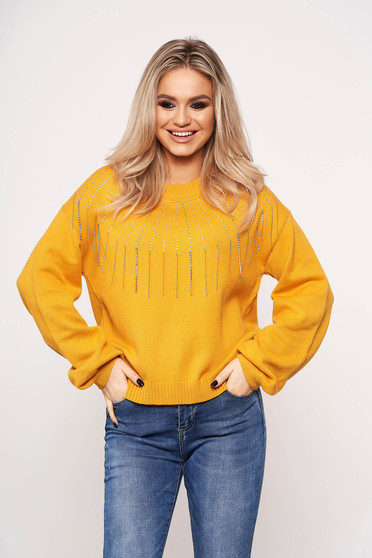 Mustard sweater long sleeve with crystal embellished details with rounded cleavage accessorized with chain casual
